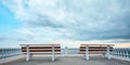 Viewing platform with bench. Empty promenade. Stormy dark sky. Virgin nature. Summer view. Ocean scenery. Royalty Free Stock Photo