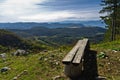 Viewpoint with a bench at mount Bobija, beautiful view of surrounding peaks, hills, meadows and colorful forests Royalty Free Stock Photo