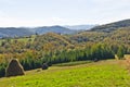 Viewpoint on a landscape of mount Bobija, hills, haystacks, meadows and colorful trees Royalty Free Stock Photo