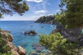 Views of the coast in `Punta des Forcats` with boats in Calella de Palafrugell.