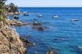 Views of the coast in `Ses Negres` with boats in Calella de Palafrugell.