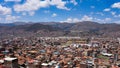 Views of Cusco airport and the San Sebastien district from Rumiwasi. Cusco, Peru