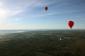 Views of field, balloons, countryside, blue sky and horizon