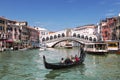 Views of the Grand canal, gondola with tourists and the Rialto bridge. Venice Royalty Free Stock Photo