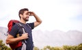 The views great from up here. a young man enjoying a hike through the mountains.