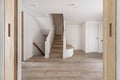 views of a large hall of a recently renovated modern house with a white oak wooden bench with drawers, a white wardrobe next to Royalty Free Stock Photo