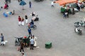 Views of the food market and shops of the Jemaa el Fna square in Marrakech with people at dusk