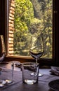 Views of a mountain forest from a window of a rustic restaurant of a mountain hotel, light entering and subtly illuminating a