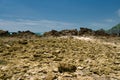 Rocky beaches and hills against the blue sky.