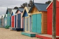 Views of rows of colourful beach bright painted summer holiday bathing box`s along a sandy beach on a sunny day, Brighton beach,