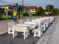 Views of rows of white marble tables and chairs lined up on the paved stone floor paved a way