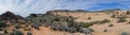 Views of sandstone and lava rock mountains and desert plants around the Red Cliffs National Conservation Area on the Yellow Knolls Royalty Free Stock Photo