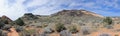 Views of sandstone and lava rock mountains and desert plants around the Red Cliffs National Conservation Area on the Yellow Knolls Royalty Free Stock Photo