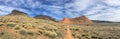 Views of sandstone and lava rock mountains and desert plants around the Red Cliffs National Conservation Area on the Yellow Knolls Royalty Free Stock Photo