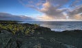 Views of the sea and black lava rocks at sunset Royalty Free Stock Photo