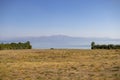 Views of the sea, steppe plains and mountain silhouettes in the distance.