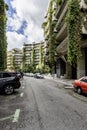 Views of an urbanization of concrete buildings with large vines trailing down the facades