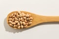 Cowpea legume. Nutritious grains on a wooden spoon on white back