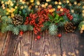 Vignette of branches of blue fir, pinecones, branches with red berries on the wooden natural background. Christmas nad New Year Royalty Free Stock Photo