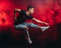 Vigorous dancer man in the air isolated over smoky space