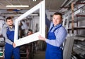 vigorous male professional labours with finished PVC profiles and windows Royalty Free Stock Photo