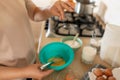 vigorously whisking eggs for pancakes