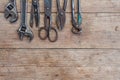 Viiew of vintage rusted tools on old wooden table: pliers, pipe wrench, screwdriver, hammer, metal shears, saws and other. Royalty Free Stock Photo