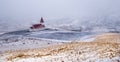 Vik I Myrdal church at the top of the hill during heavy snow at the village of Vik in Iceland in winter.