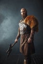 Viking with axe, barbarian, side view