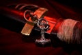 Viking battle sword made of steel with a leather handle with a Thor`s silver Hammer pendant on a red black background