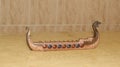 Censer. Censer decorative viking boat made of resin to burn incense, side view and travertine marble base