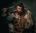 Viking with cold weapon in a traditional warrior clothes Royalty Free Stock Photo