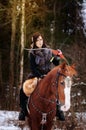 A Viking girl riding on horse painted in black runes. holds a bow and shoots it Royalty Free Stock Photo