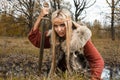 Viking girl with sword in a fog wood Royalty Free Stock Photo