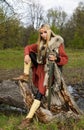 Viking girl with sword in a wood Royalty Free Stock Photo