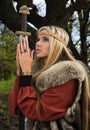 Viking girl with sword in a wood Royalty Free Stock Photo