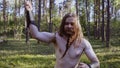 Viking with a knife performs melee techniques looking at the camera.