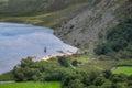 Viking longships moored on a dock, village at the Guiness Lake in Wicklow Mountains Royalty Free Stock Photo