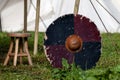 Viking shield leaning against a tent peg