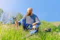 Viking warrior man with ax in emotional pose. Metal helmet on his knee. Historical photo concept Royalty Free Stock Photo