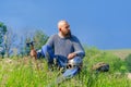 Viking warrior man with ax in emotional pose. Metal helmet on his knee. Historical photo concept Royalty Free Stock Photo