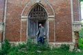 Viking warrior near an old brick castle . Sword and helmet. Pensive look. Old wooden door in the form of an arch Royalty Free Stock Photo