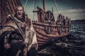 Viking warrior with sword standing near Drakkar on seashore