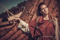 Viking woman standing near Drakkar on the seashore.