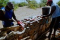 local fisherman cleaning the catch in the shade to get away from the tropical heat