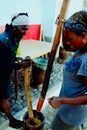 local woman grinding corn on the traditional way