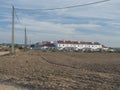 Vila Nova de Milfontes, Portugal, October 25, 2021: View over field to Vila Nova de Milfontes white and blue houses in Royalty Free Stock Photo