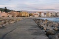 Vila Praia de Ancora, Portugal - 15/10/2018: Empty pier with stones and town in the evening. Calm coastal town landmark.