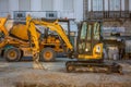 View of a excavator and a concrete mixer on the construction site