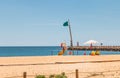 Lifeguard dressed in yellow sitting on a chair on the beach Royalty Free Stock Photo